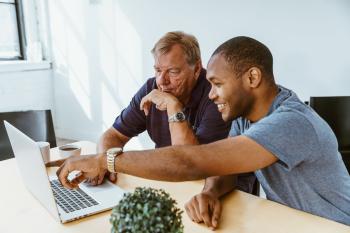 Photo of young man helping older man to make a small claim